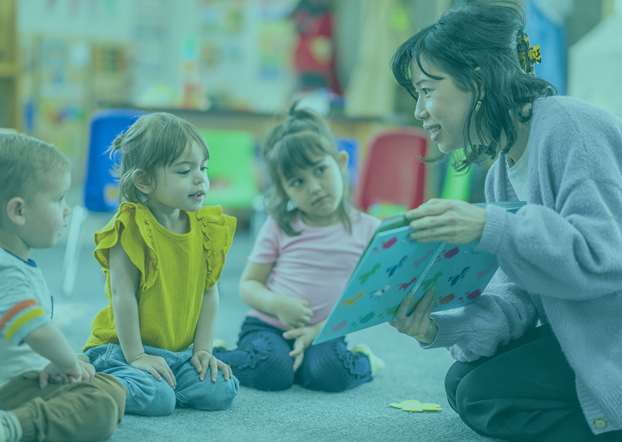 Woman reading to students