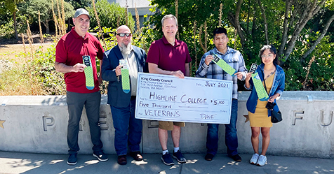 Highline College Vice President Josh Gerstman, Kendall Evans with Veterans Services and Highline College students stand with King County Councilmember Dave Upthegrove as he presents a $5,000 grant for Highline's Veterans Services program.