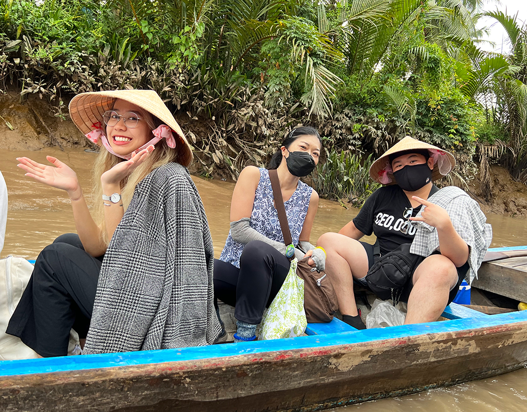 Students and faculty in a row boat along the Mekong Delta in Vietnam.